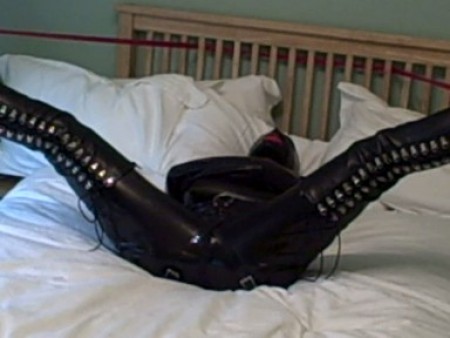 Adreena In Rubber Straitjacket Bondage - Adreena is dressed in catsuit, rubber straitjacket, thigh boots and fellatio hood.  Her ankles are roped to the bed head and we see adreena struggle to break free and escape.  Watch this clip and see what three minutes of serious effort on her part produces. ;